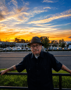 Man in hat in front of a Sunset