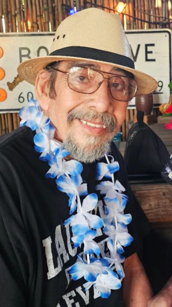 Smiling man with lei flowers