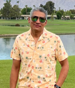 Man in yellow shirt at a golf course
