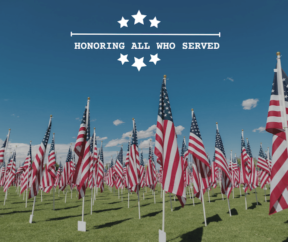MemorialDayBlog A field of flags in honor of Memorial Day. Words say Honoring All Who Served