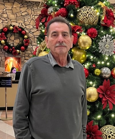 Man in front of Christmas Tree