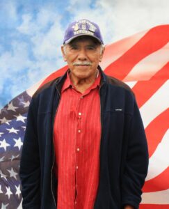 Man in front of flag