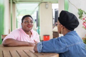 Two people talking to each other at a table