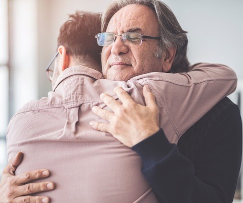 Two people hugging, comforting one another