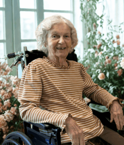 Woman in Wheelchair with Roses in Background