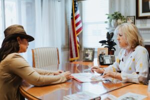 Two people go over paperwork in an arrangement room at the mortuary