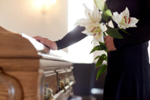 Man with his hand on casket